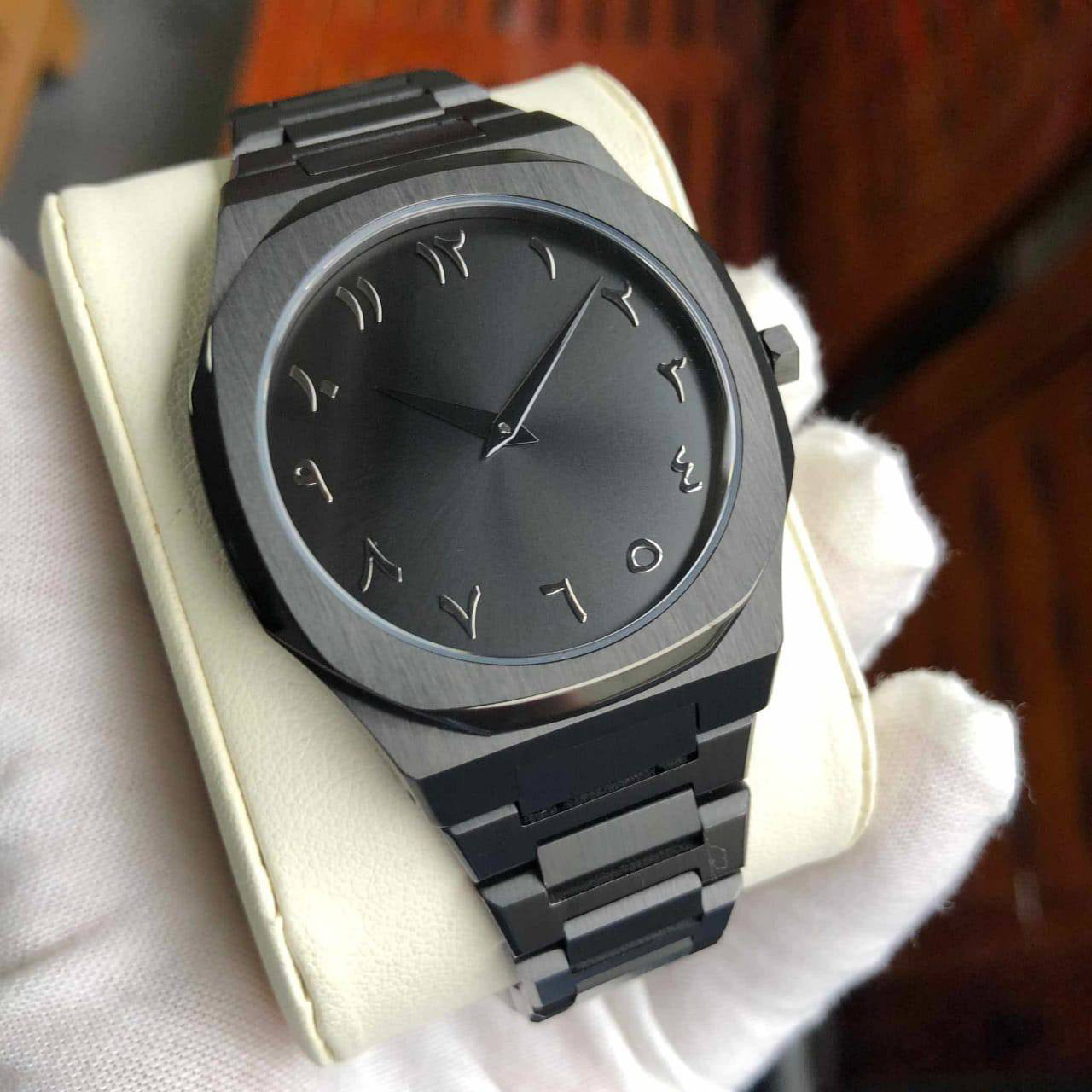 Black wristwatch with a metallic band on a white cushion